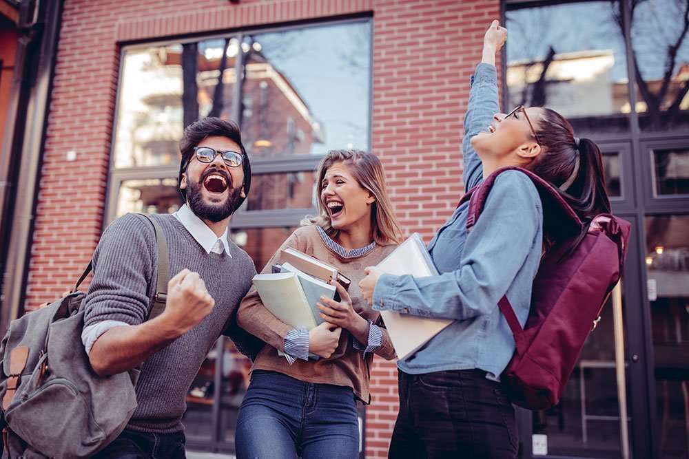 Students celebrating outside of school.